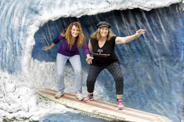 Karen Duquette and Ilse Blahak Surfing in front of Lincoln City Surf Shop